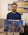 man holding a super hero canvas he received as a gift